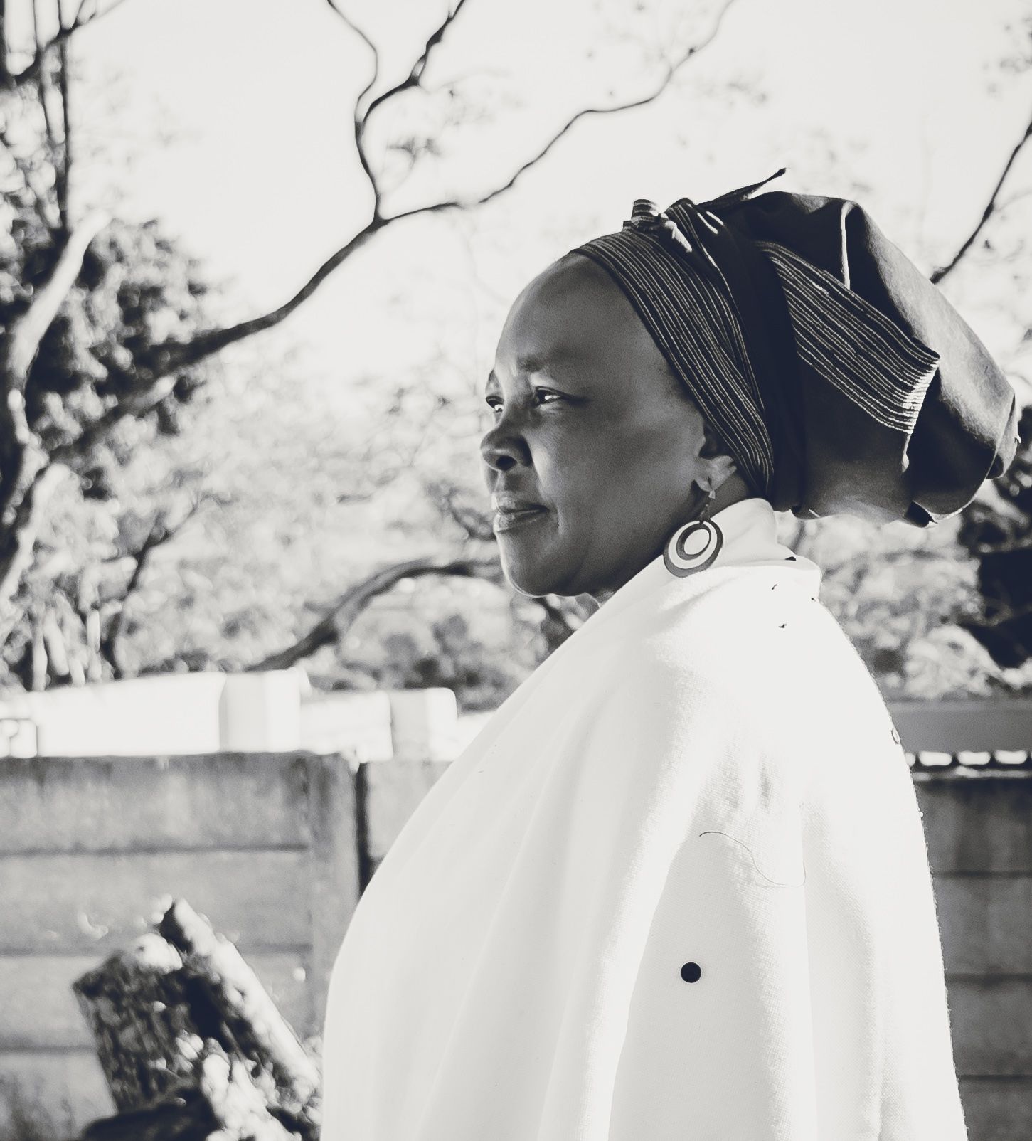 A woman wears traditional attire as she poses for a black and white image.