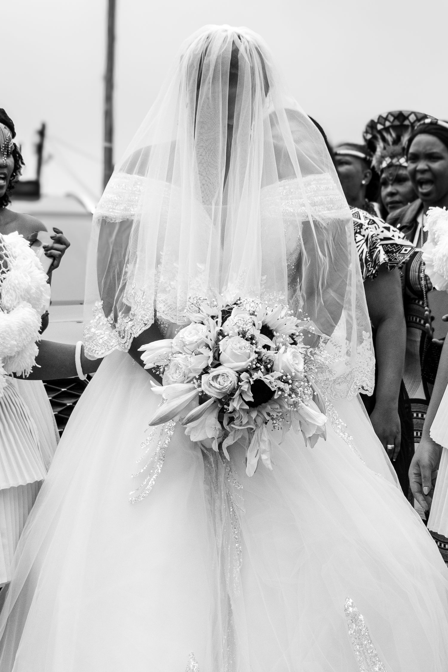 All smiles as the couple smile at each other during their white wedding ceremony.