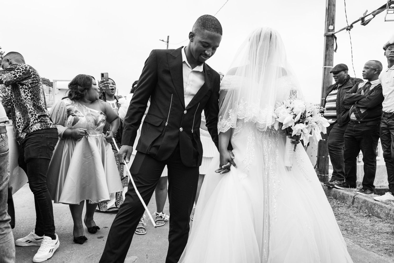 Bride and groom as they enter the reception area in a white wedding held in Durban.