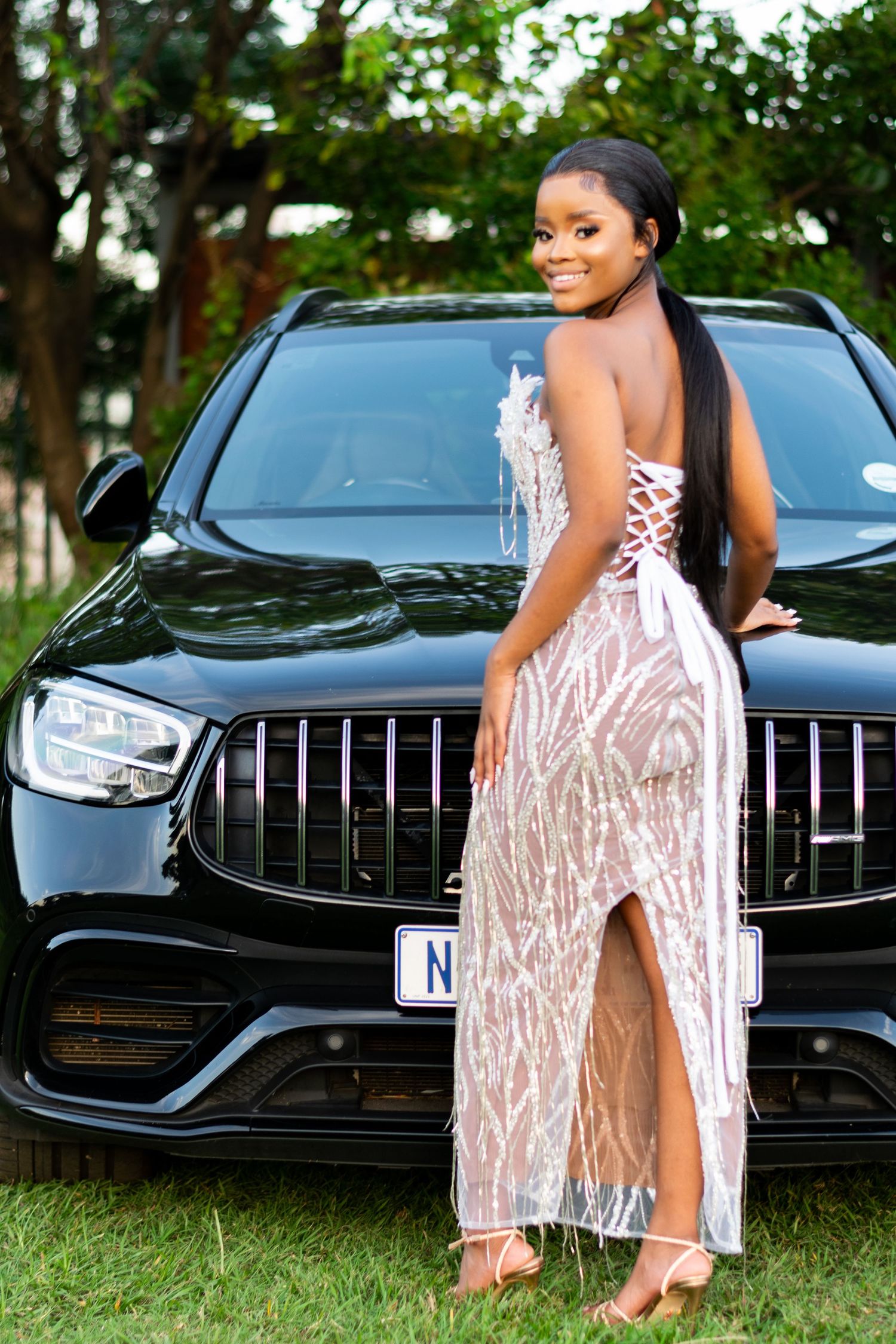 A woman posing next in front of the car during a matric farewell photoshoot in Durban.