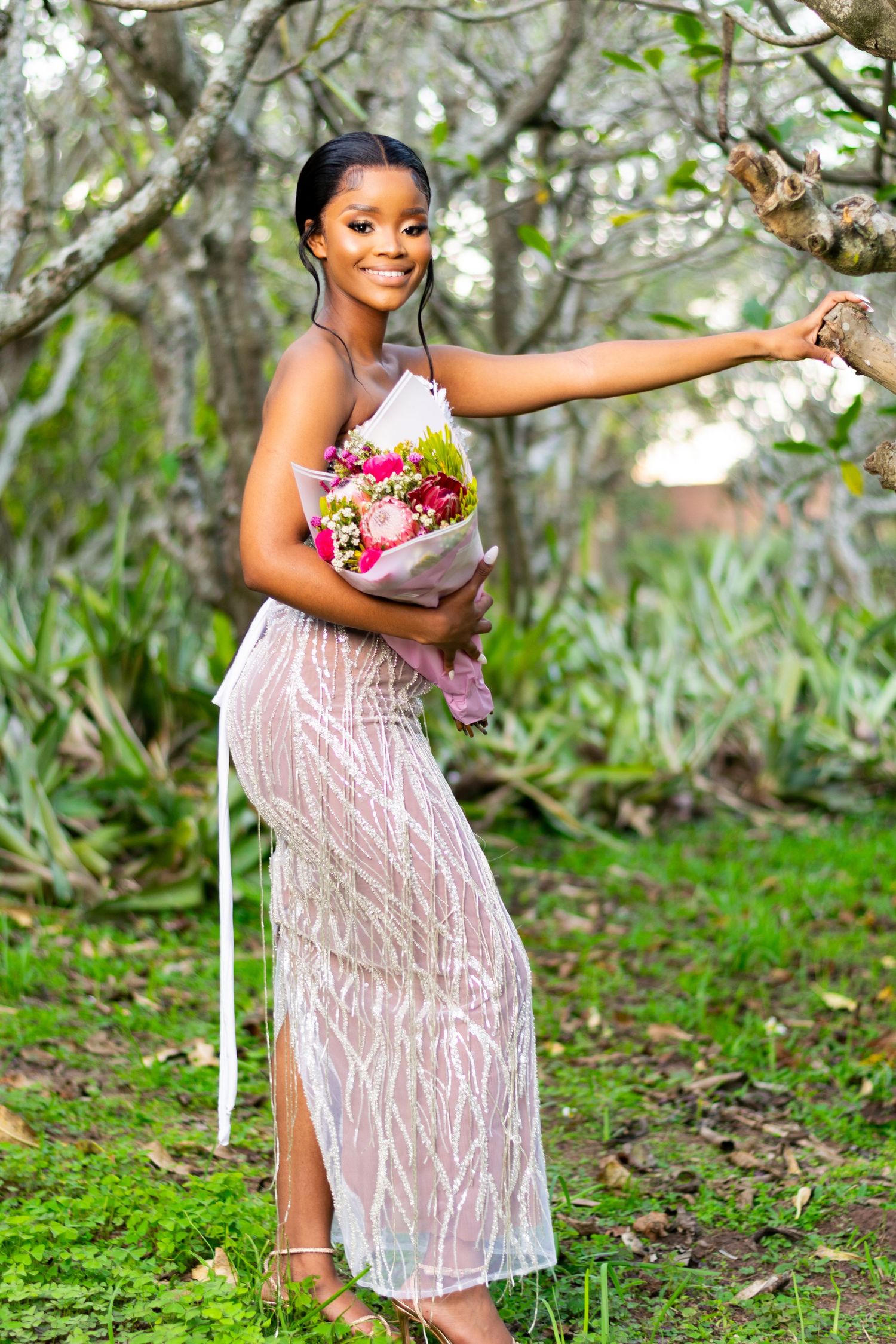 A woman posing next to a tree for a matric farewell photoshoot held in Durban.