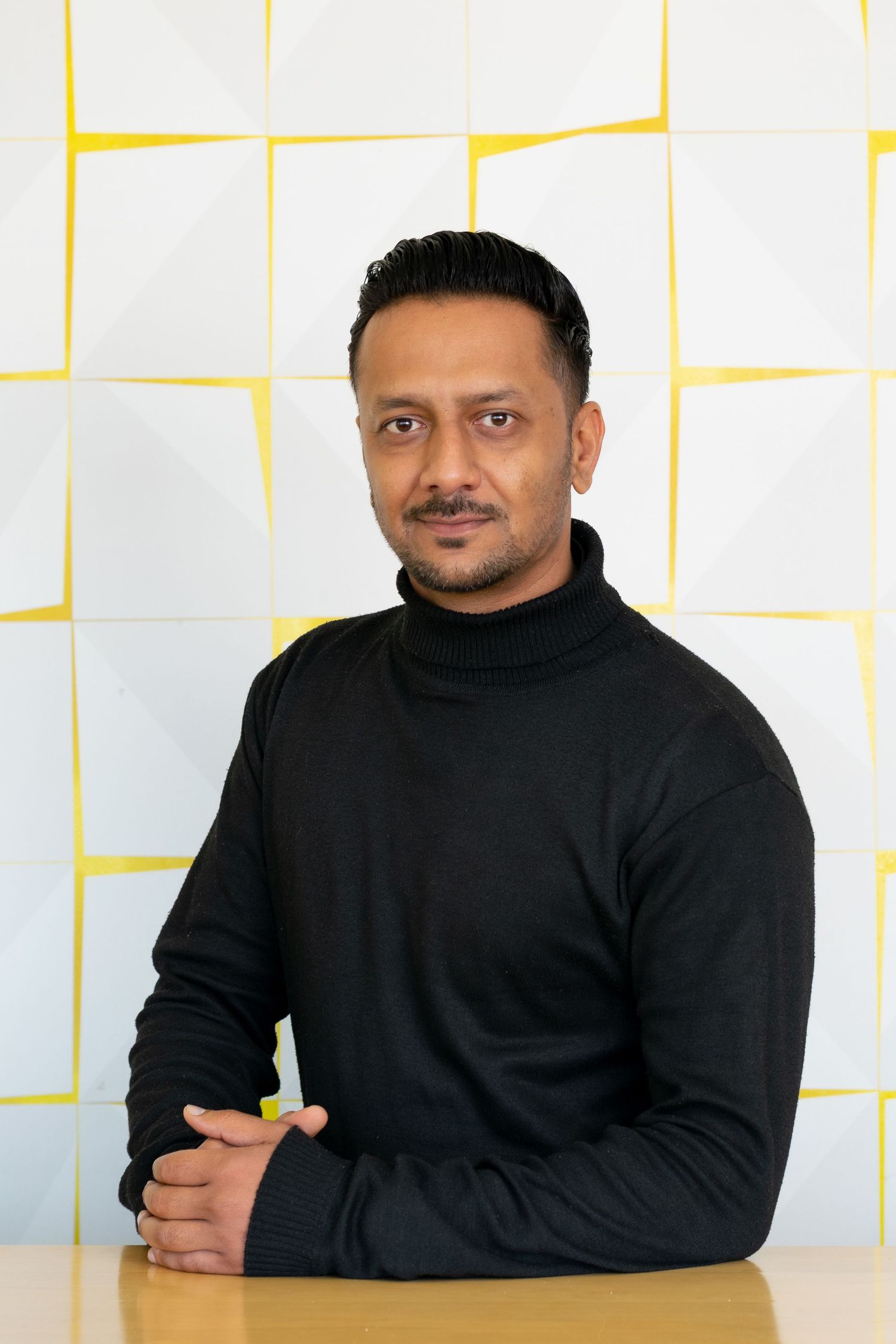 A man posing for a corporate photoshoot held in Durban, KwaZulu-Natal.