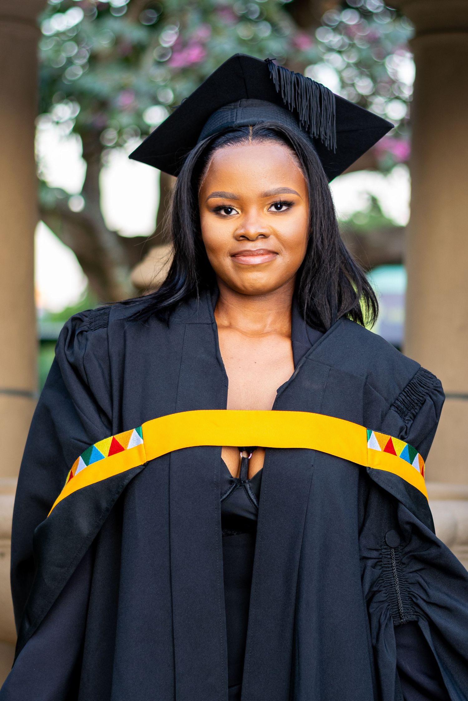 An image of a graduate in botanic gardens, Durban.