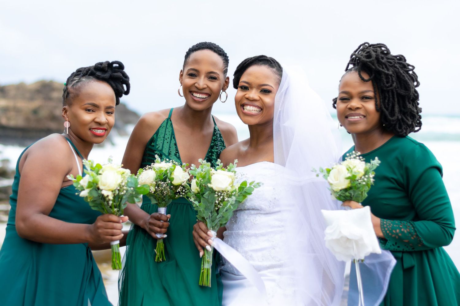 A bride taking a picture with bridesmaid in a wedding held in Eastern Cape.