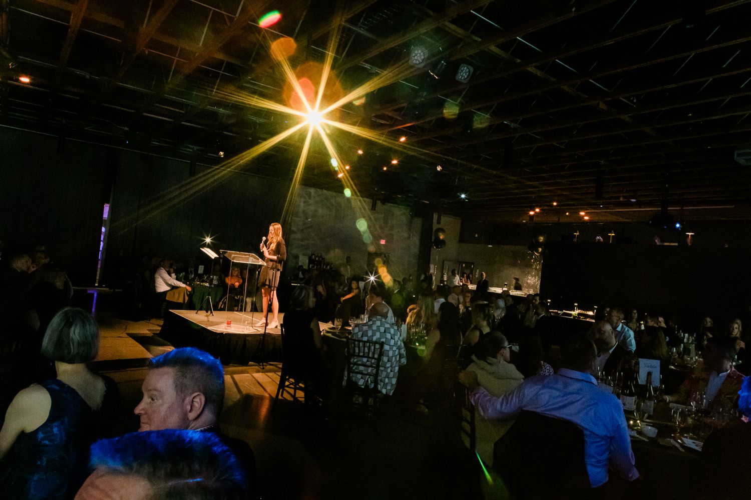 An emcee speaking at an event in Portland, Oregon