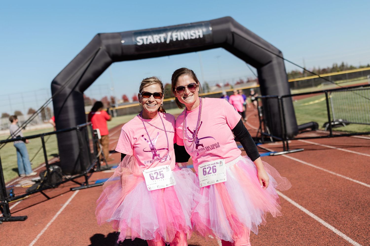 Two women dressed in tutus finishing their race at an event in Bend, Oregon