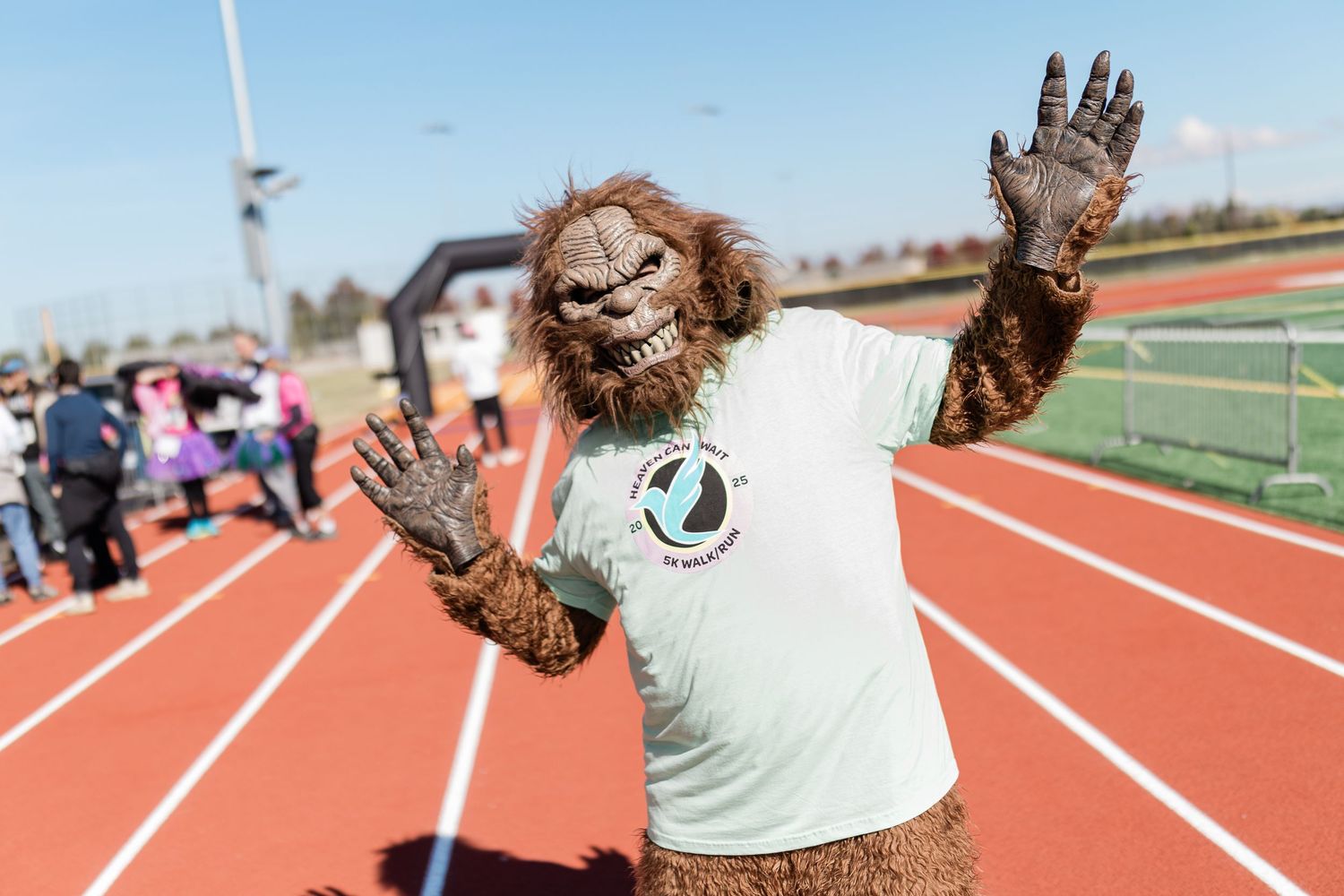 A mascot posing at the finish line at a race in Bend, Oregon