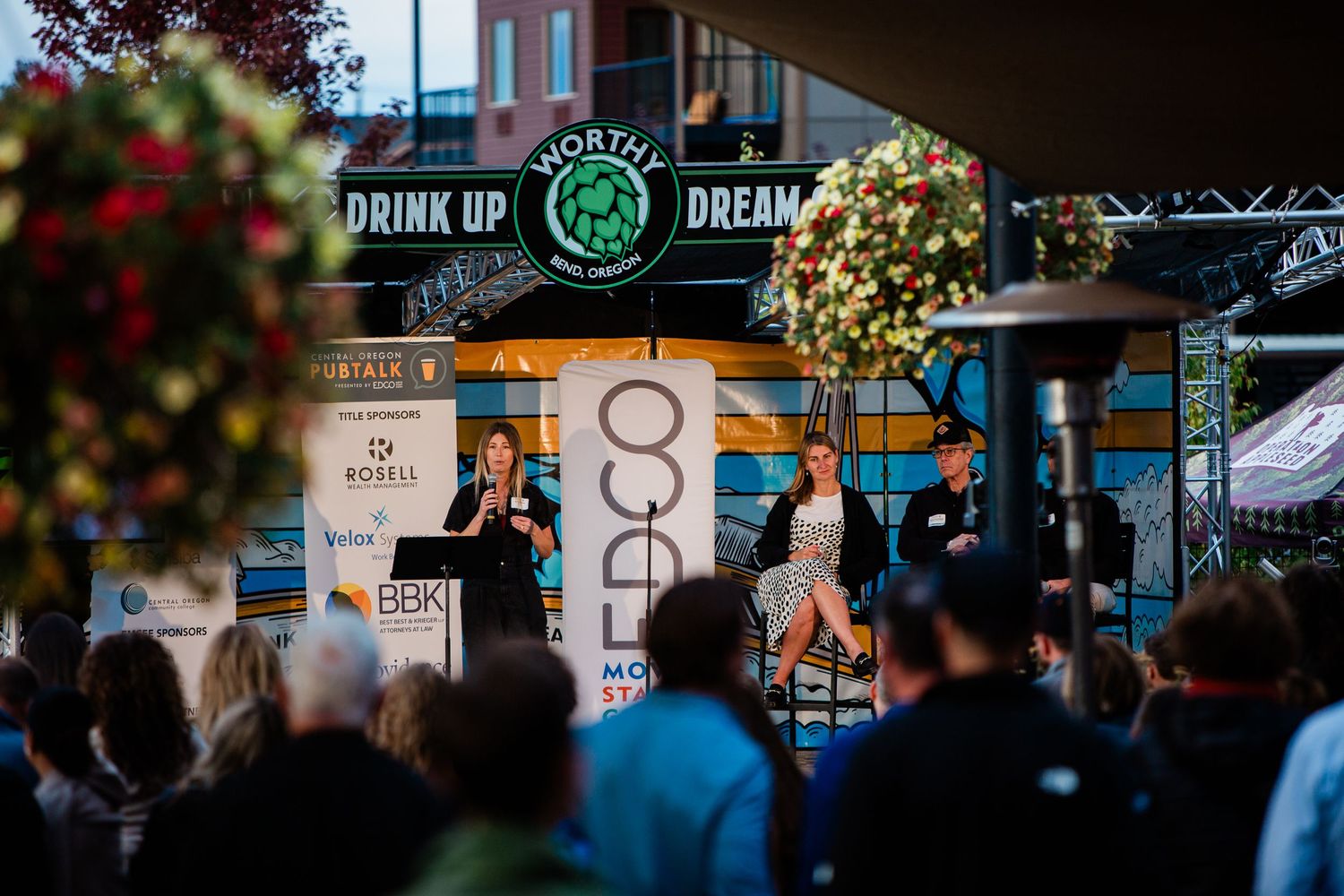 People talking on stage at an event in Bend, Oregon