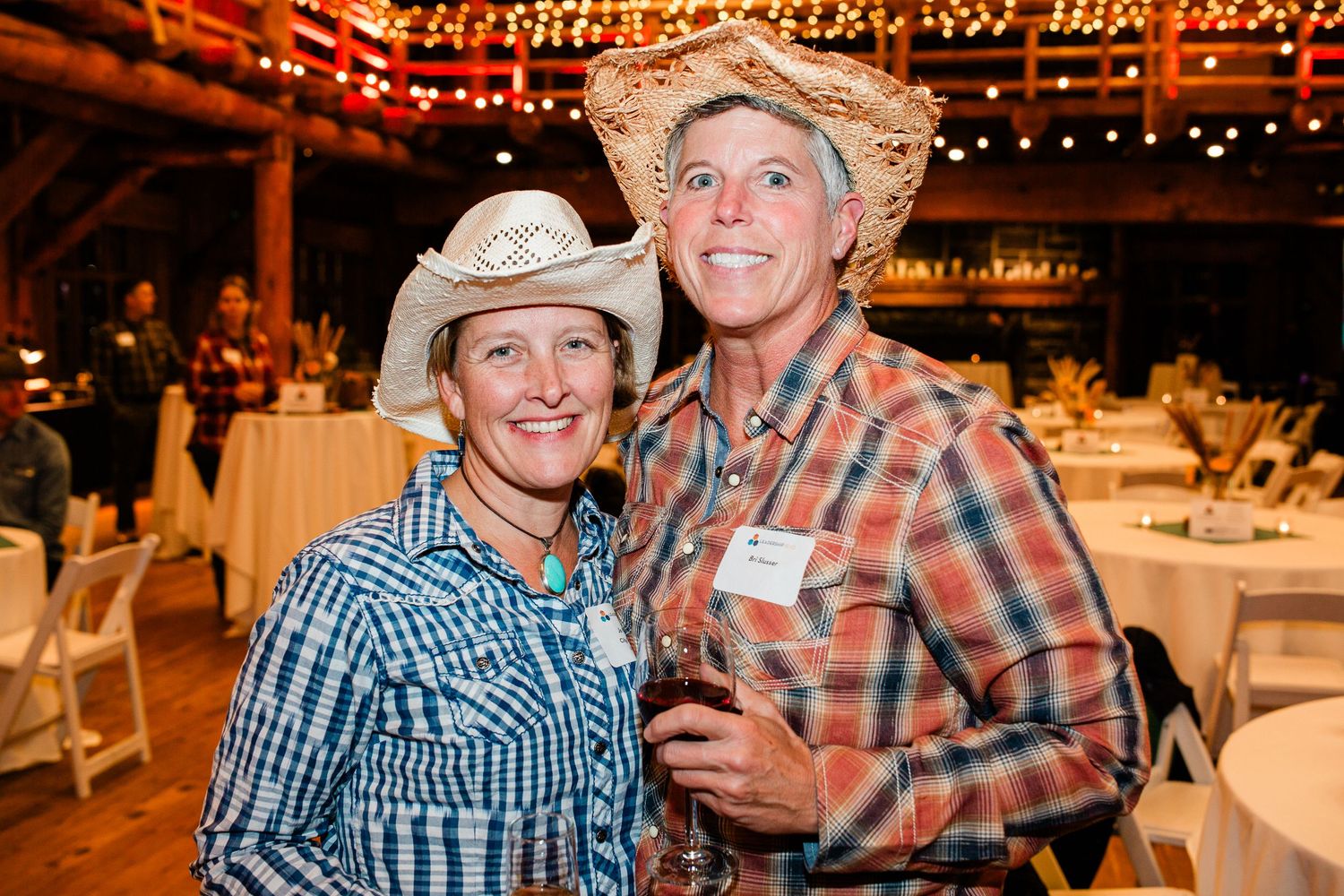 Two women enjoying an event at the Great Hall in Sunriver, Oregon