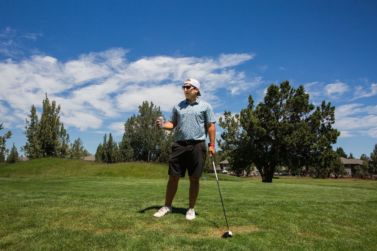A man on a golf green with a blue sky in Bend, Oregon