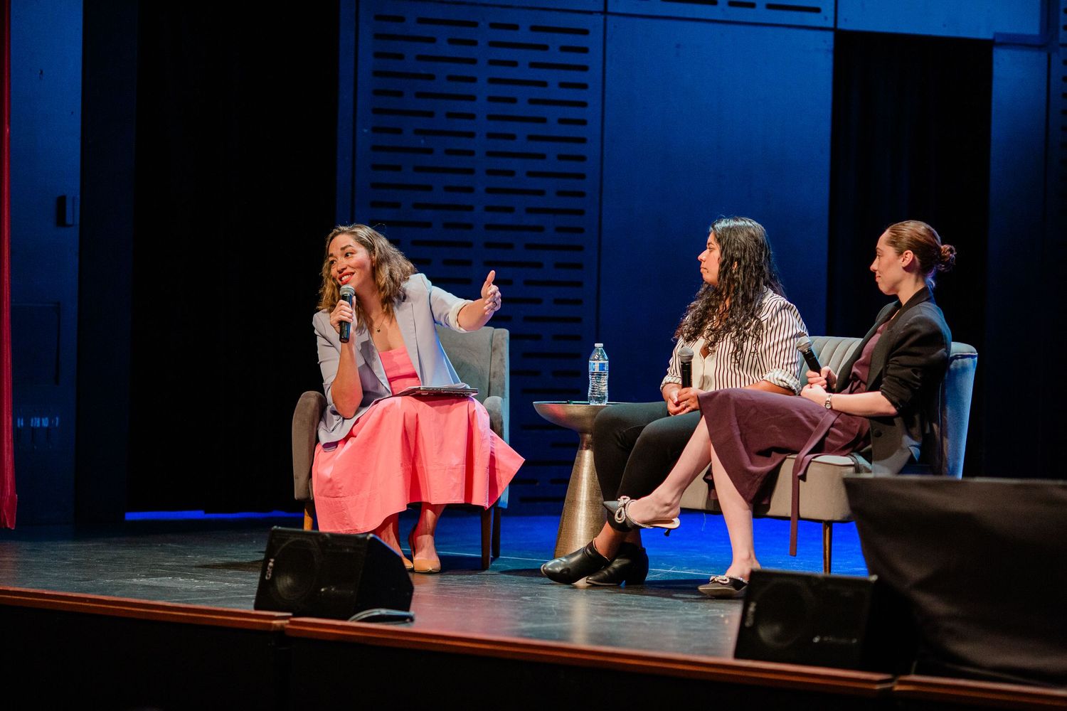 Three women speaking on stage at an event in Bend, Oregon