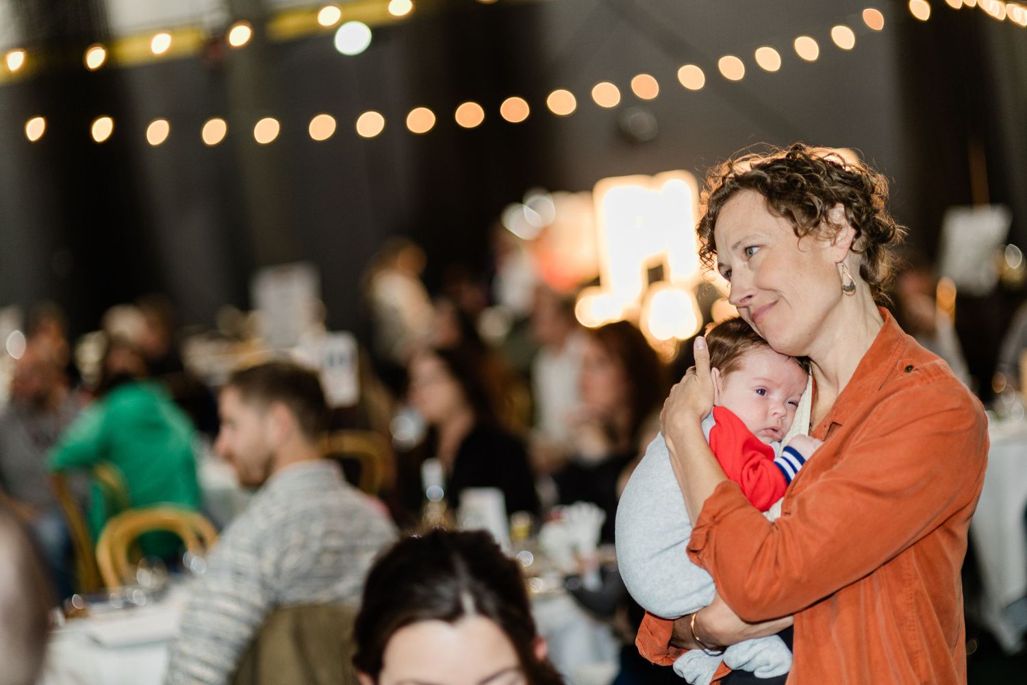 A mother holding her child at an event in Bend, Oregon