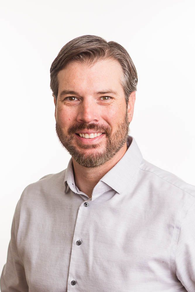 Headshot of a man in a studio setting