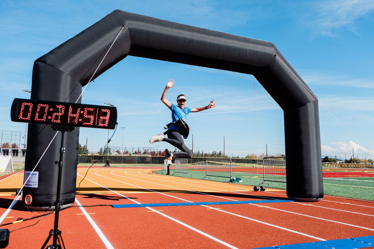 A racer jumping in the air at the finish line at a race in Bend Oregon