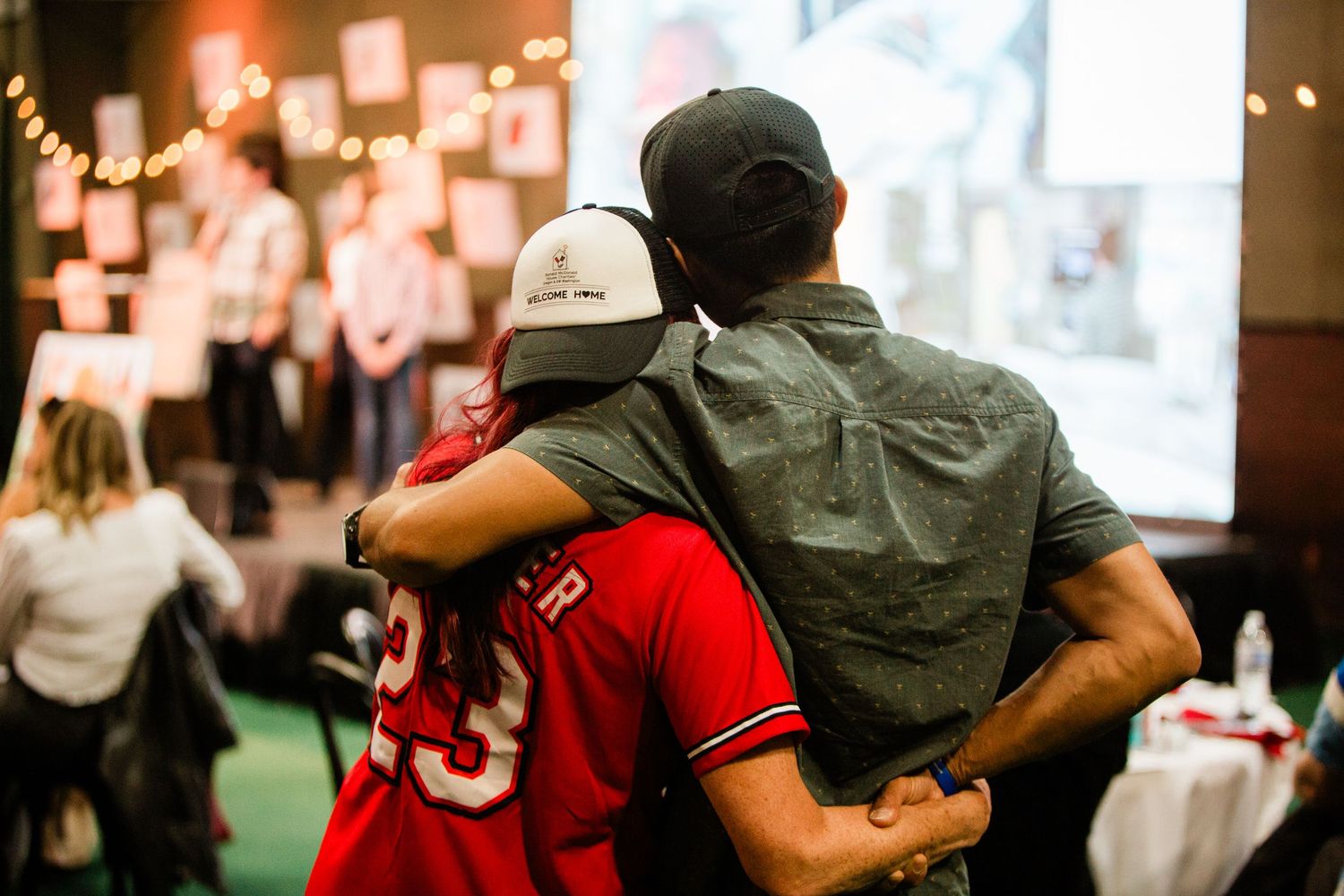 Two people with their arms around the other at an event in Bend, Oregon