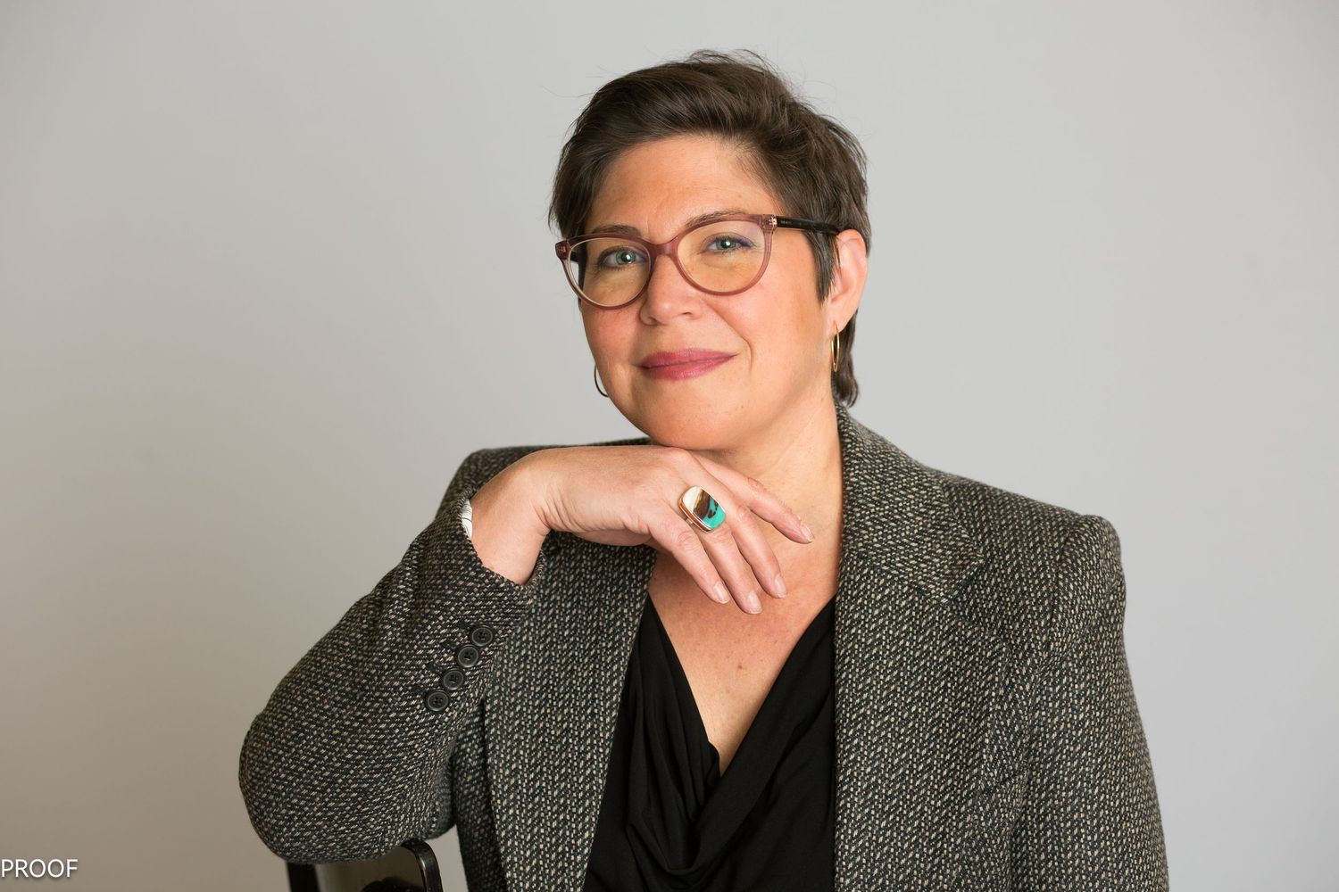 A headshot of a woman in a studio setting