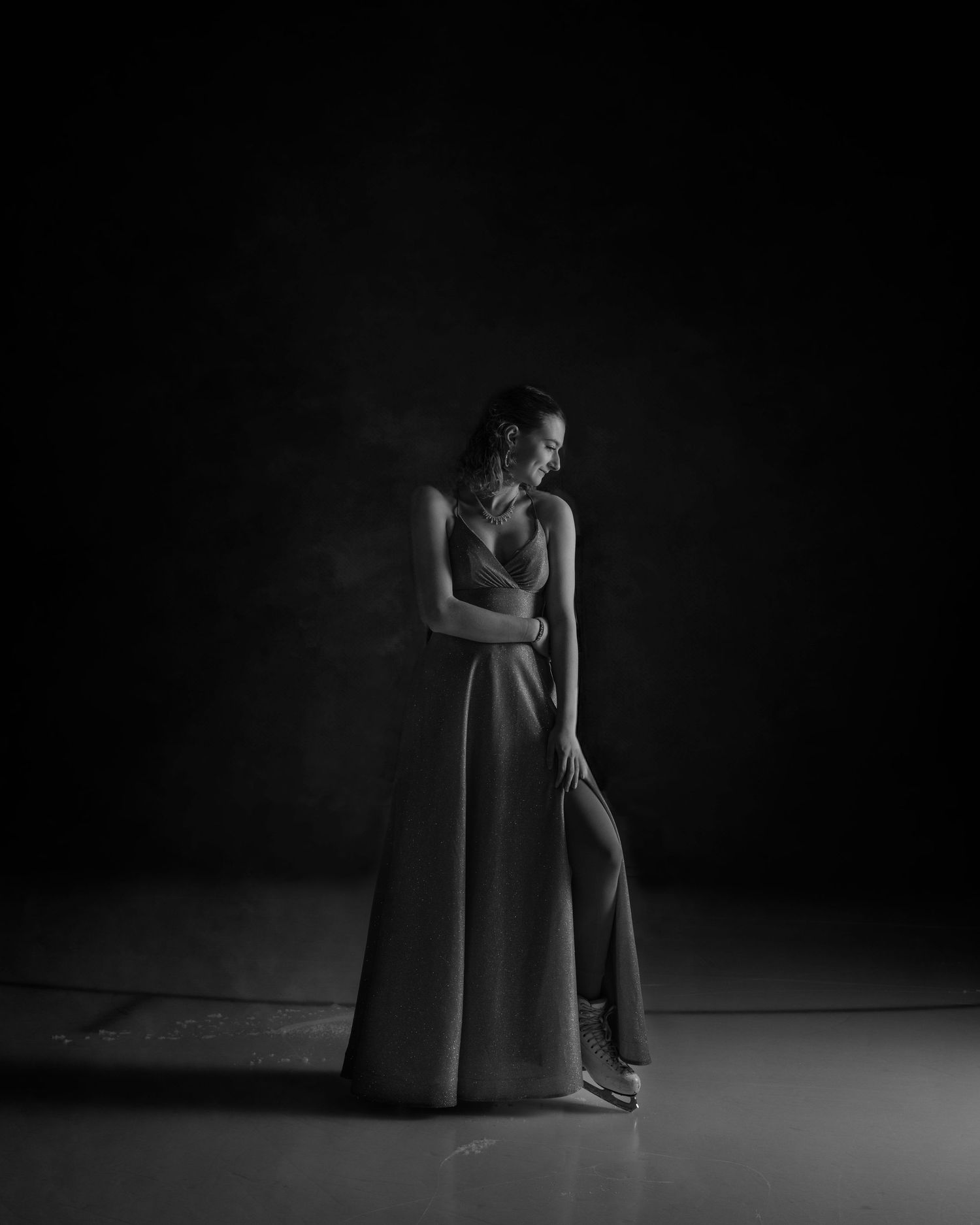 Dramatic black and white portrait series showing elegant poses in flowing dress.