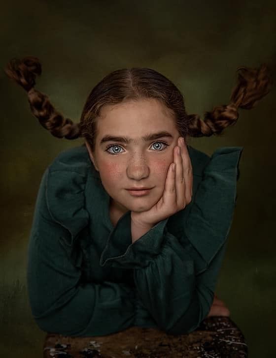 Portrait series showing expressive poses with braided hair against a moody dark background.