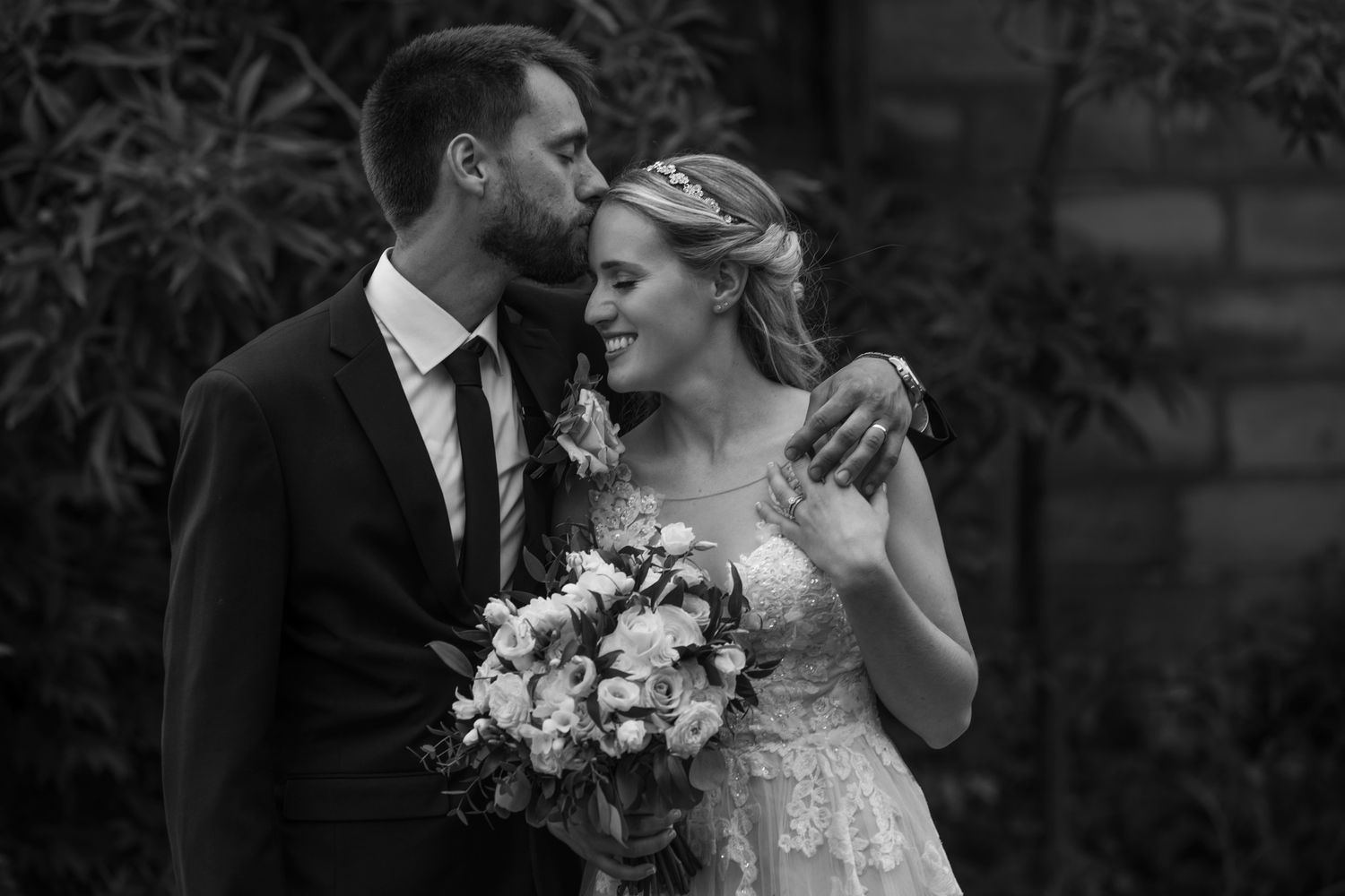 A collection of intimate black and white wedding photos showing romantic moments between newlyweds.