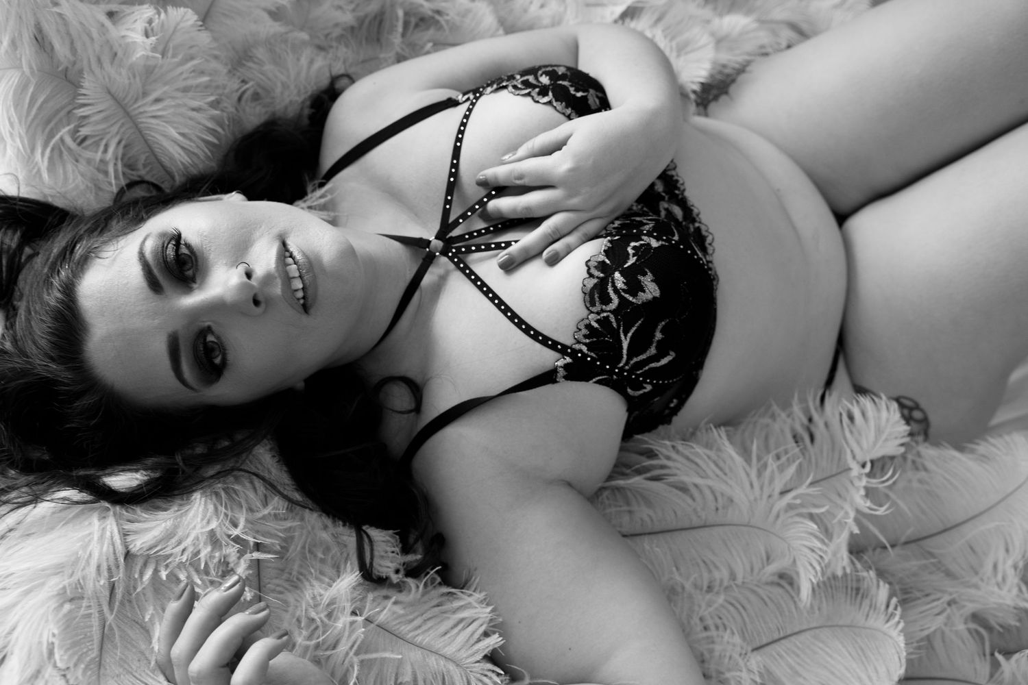 Glamour portrait series on white feathered backdrop with black lace details.