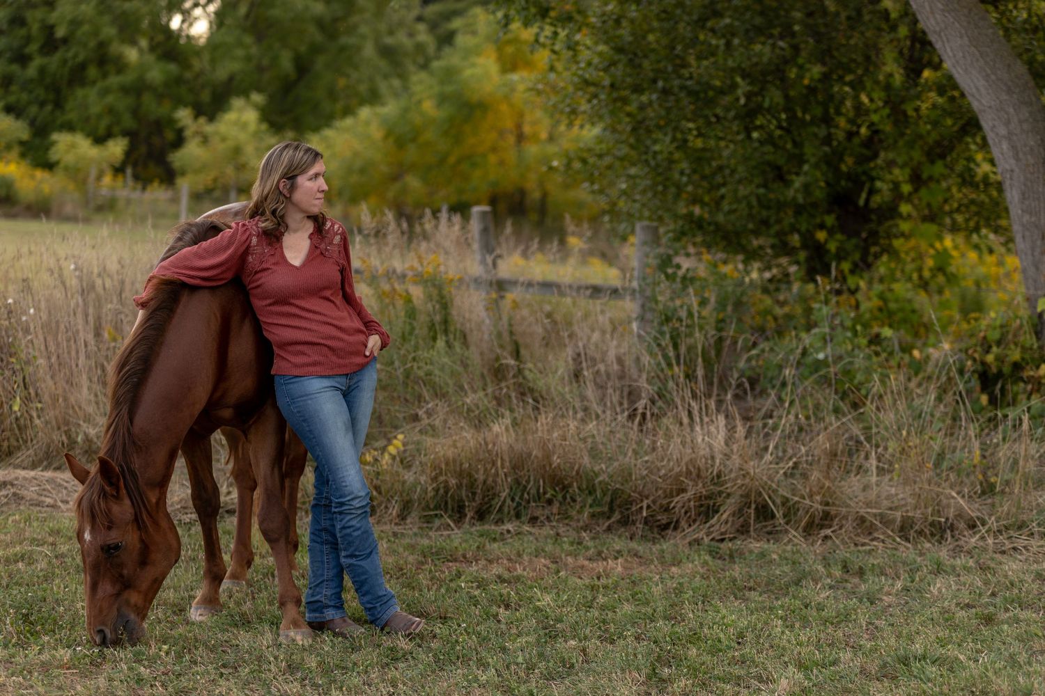 Horse and rider portraits captured in a rustic outdoor setting with fall colors.