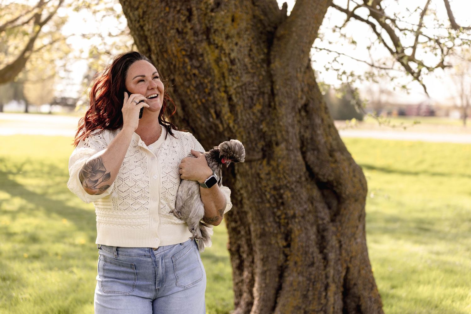 A casual spring photoshoot under a blooming tree with light denim and white tops creating a relaxed outdoor vibe.
