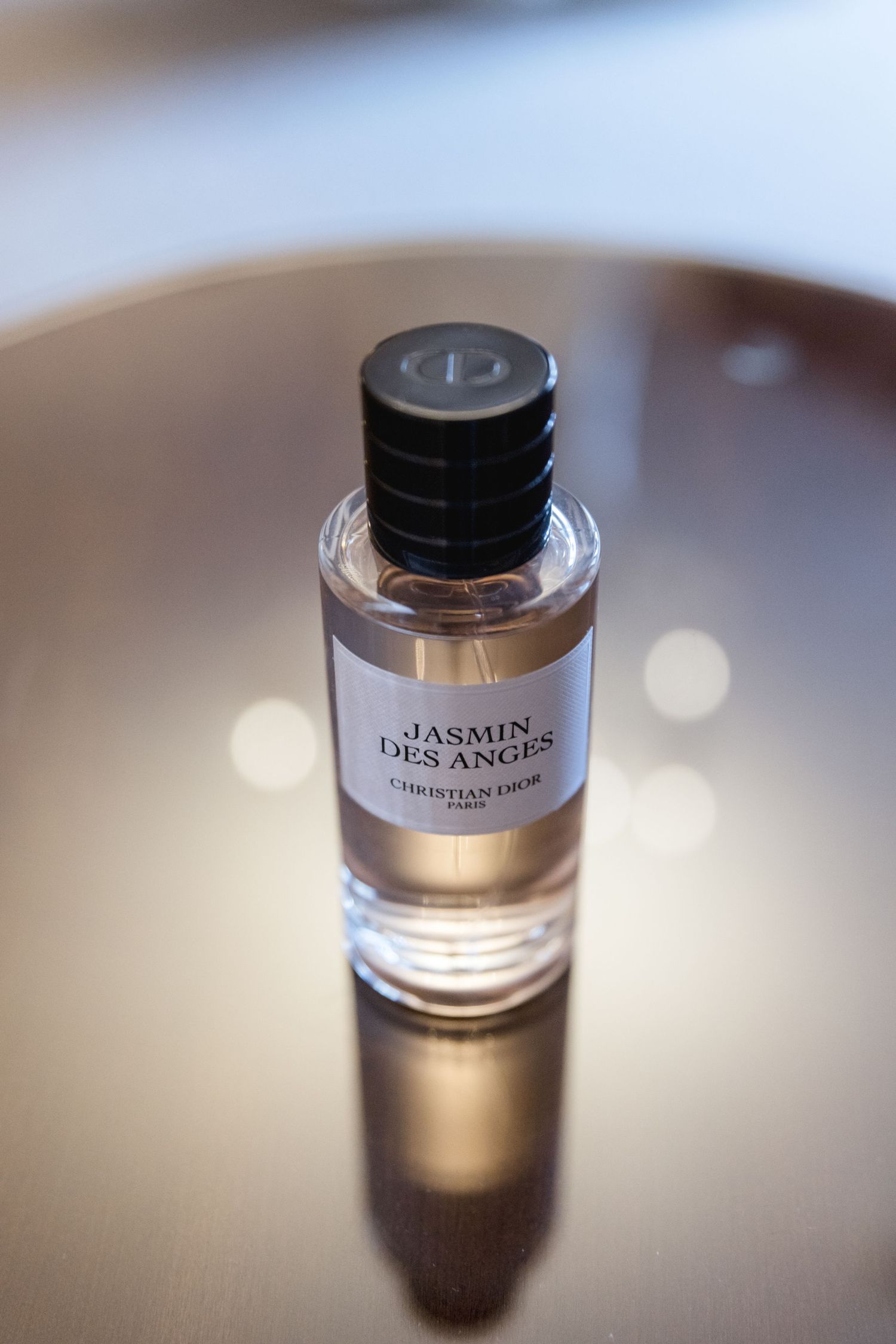 Glass perfume bottle labeled 'Jasmine' photographed with soft focus.