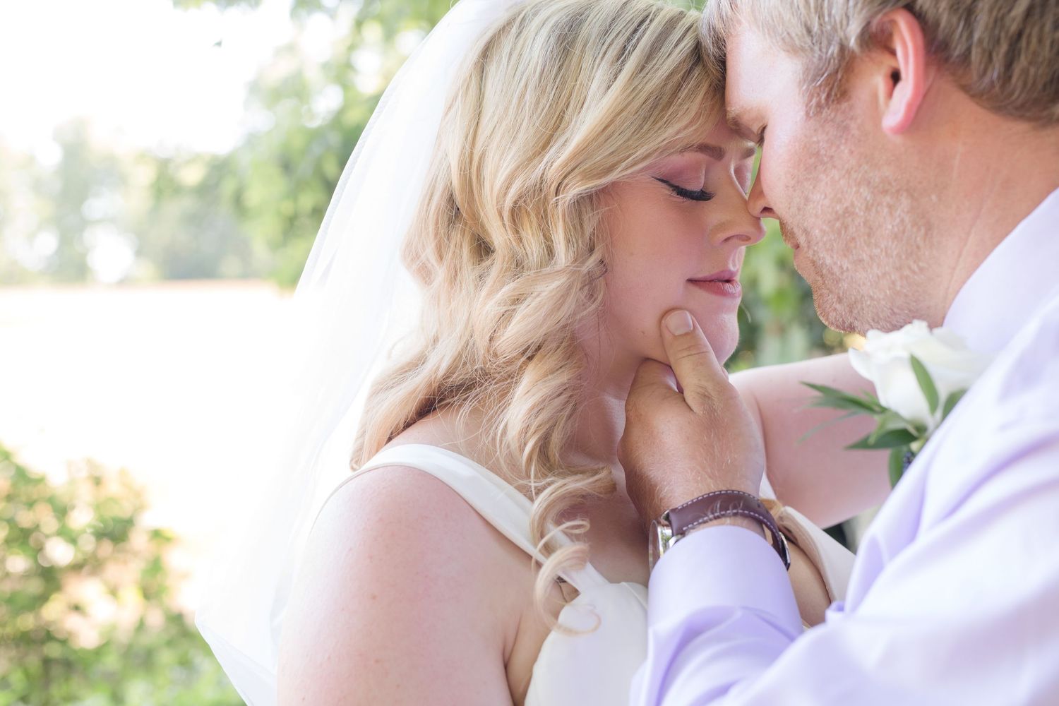 Romantic close-up portrait of a couple in soft natural lighting.