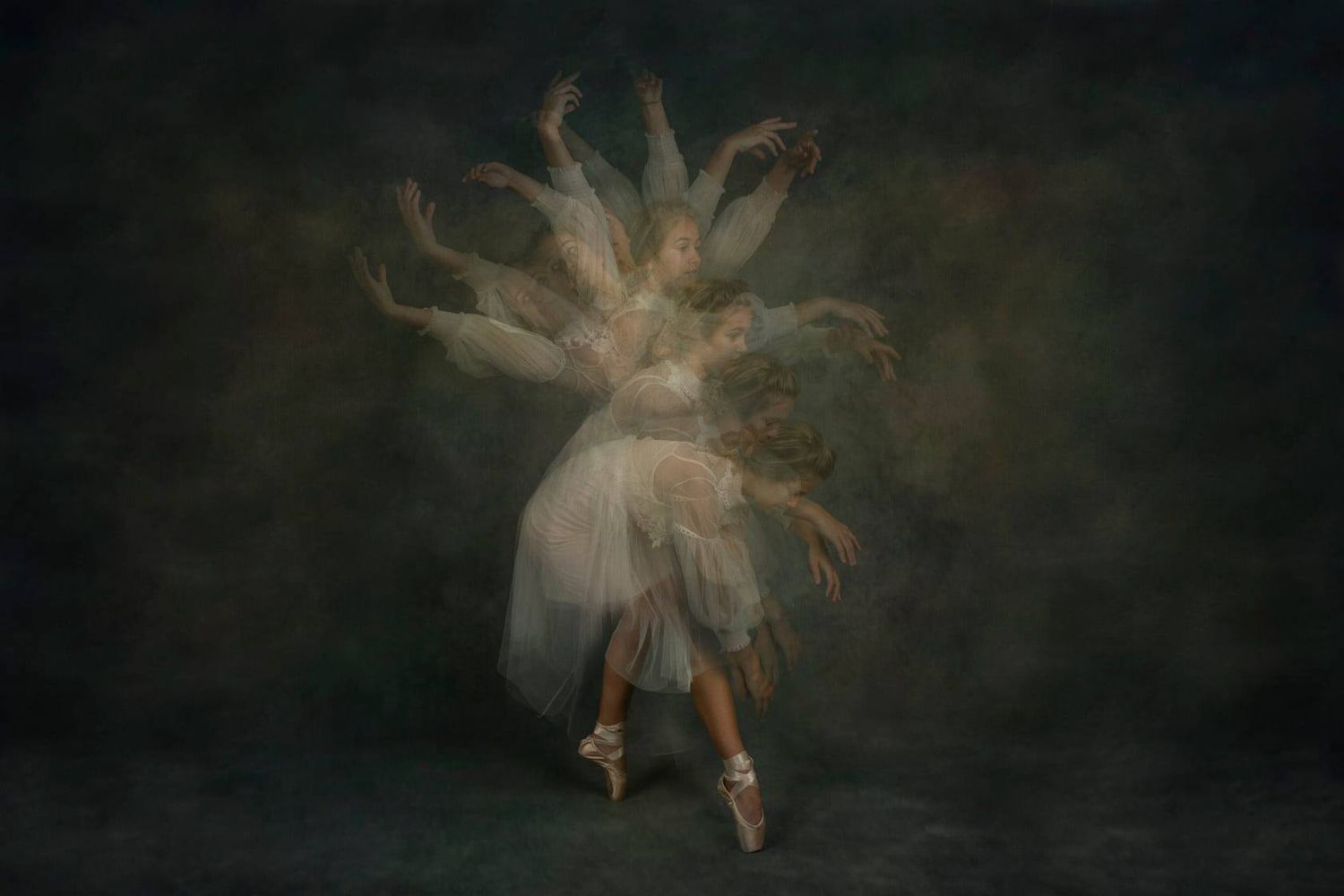 Dreamy ballet dancer in white tutu performing graceful movements in atmospheric lighting.