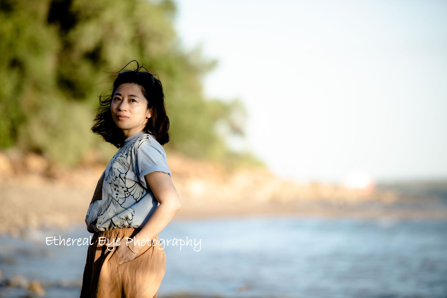 Candid outdoor portraits with natural lighting and blurred background near water.