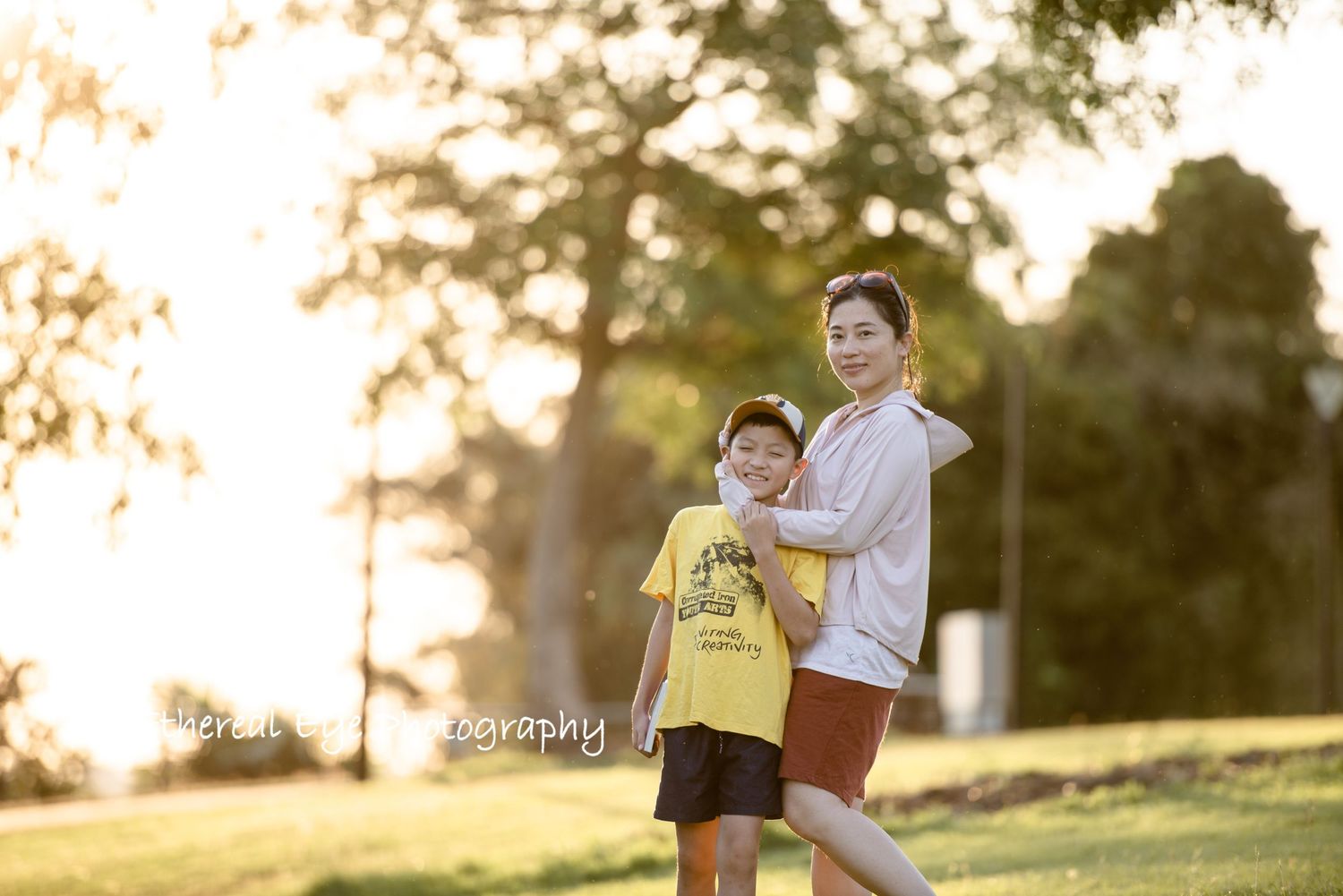 Kids in casual summer clothing exploring a sunny outdoor area with natural greenery.