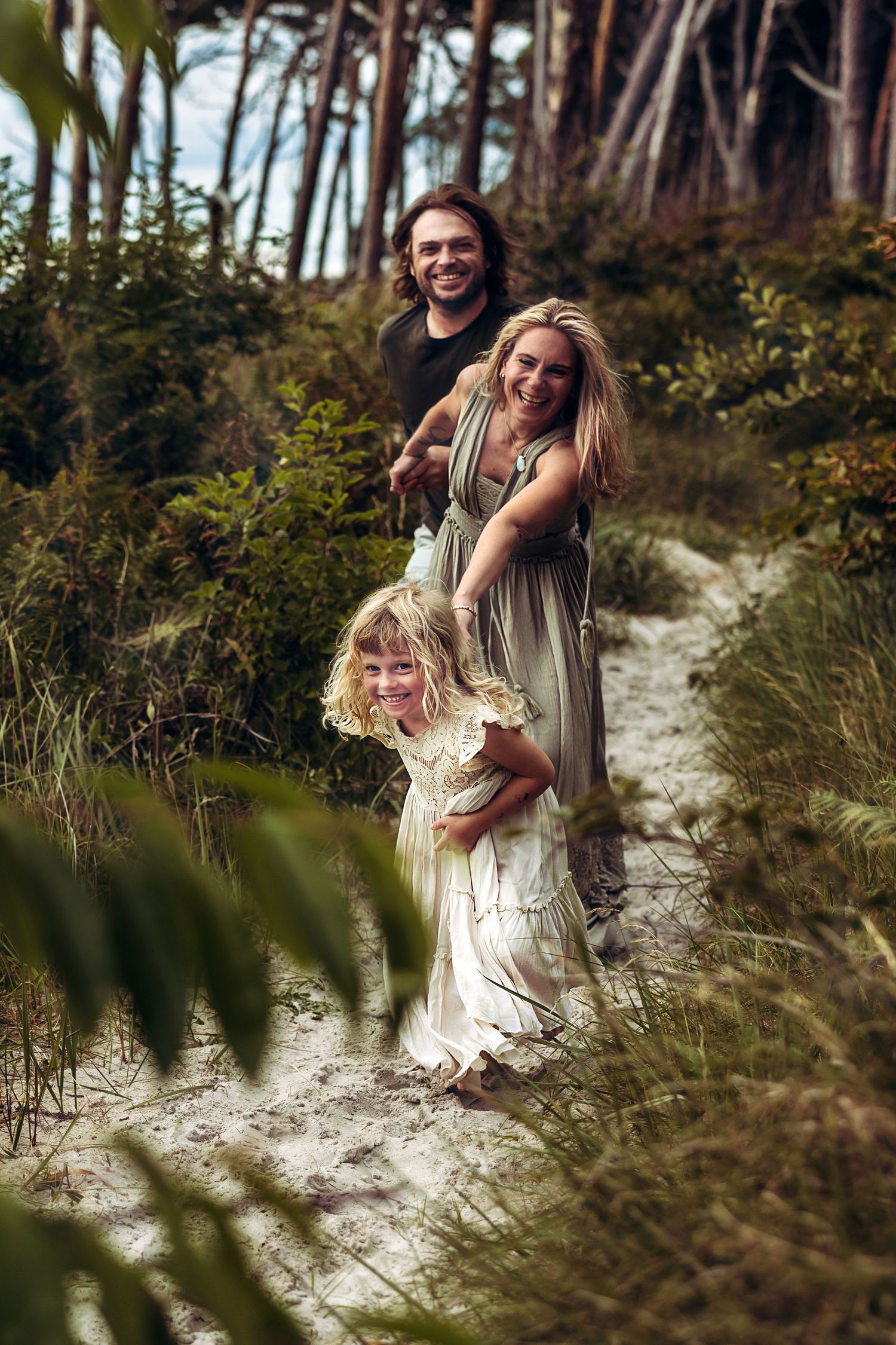 Playful moments captured in forest setting with natural sunlight filtering through trees.