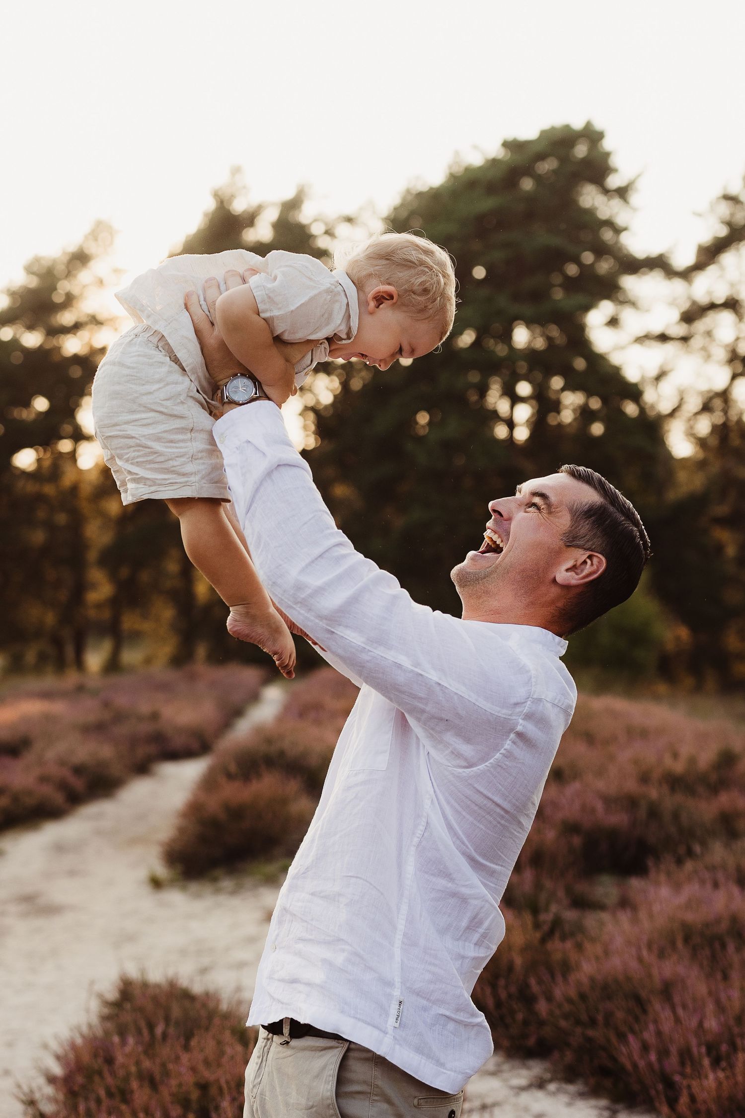 Joyful family moments captured in golden sunlight among blooming heather.