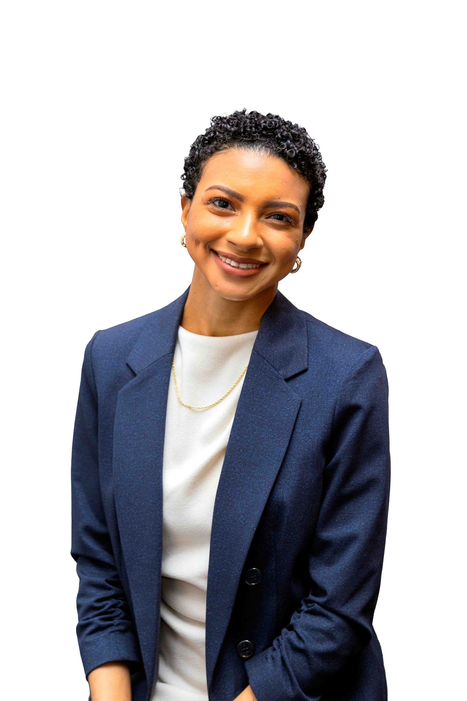 Professional woman in navy blazer and white top smiling confidently against white background.