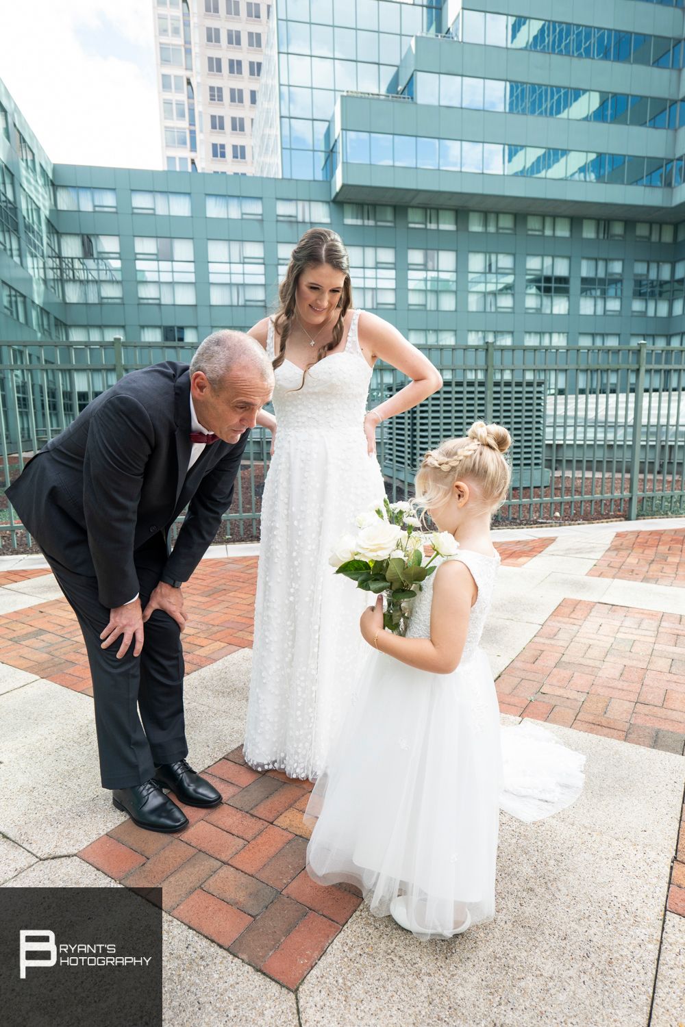 Wedding photo sequence on brick rooftop with modern glass building backdrop.