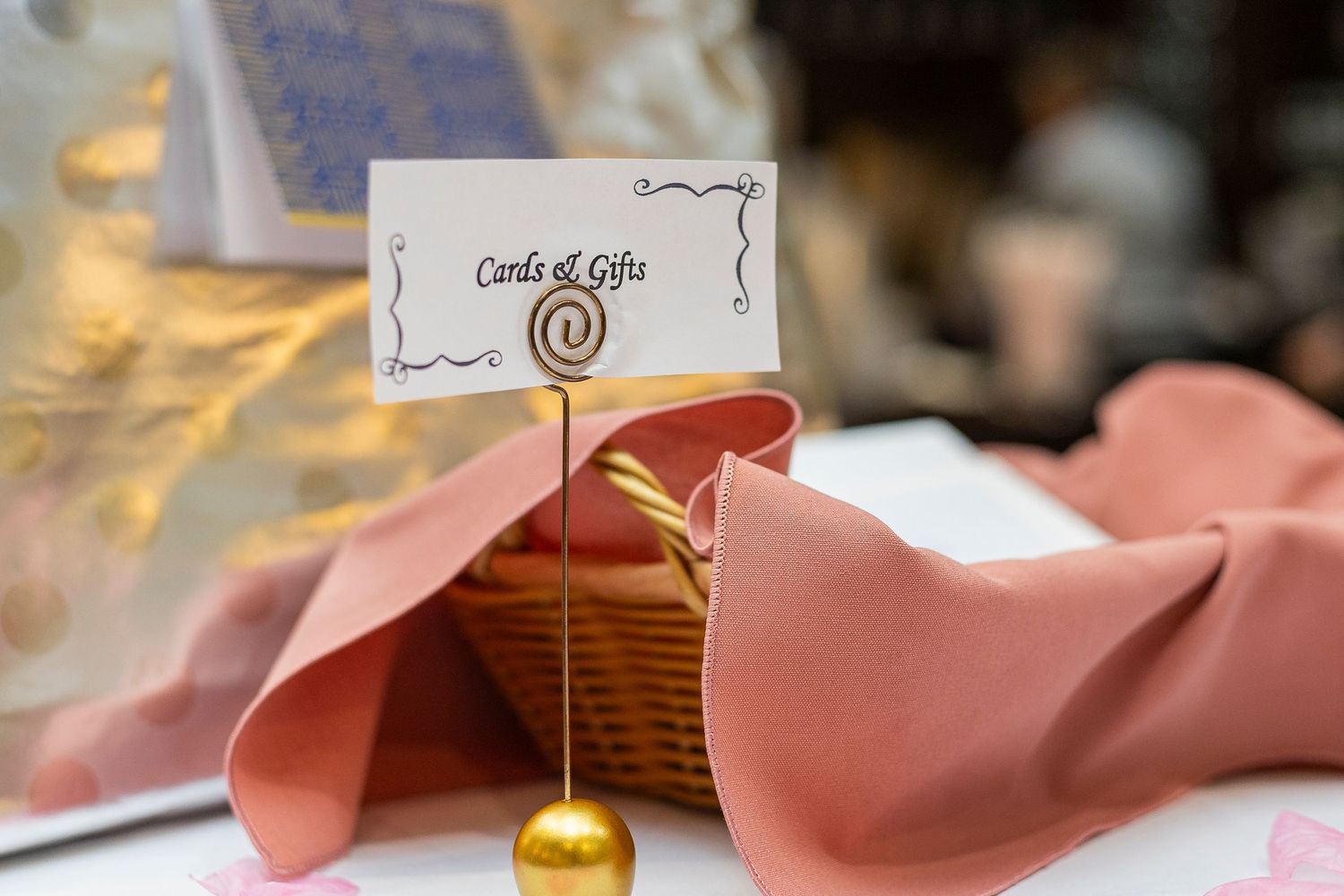 Elegant place settings with pink napkins and gold accents at a formal event.
