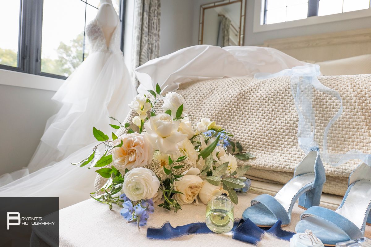 Wedding accessories and floral arrangements in soft blue and pink tones.