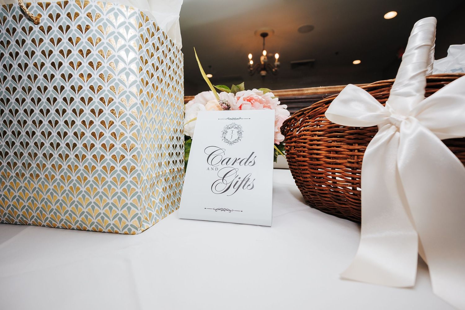 Elegant gift boxes and cards displayed at wedding reception.