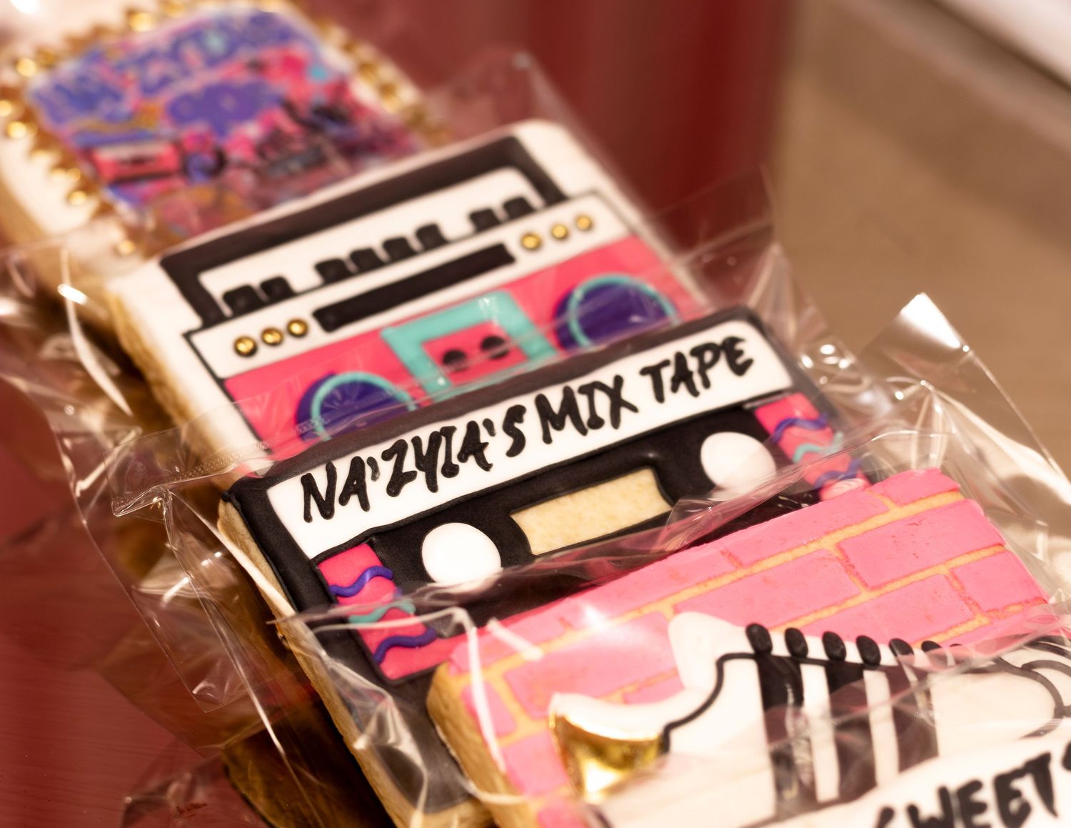 Custom decorated sugar cookies shaped like cassette tapes and boomboxes for Na'Zyia's Mix Tape sweet 16 party.