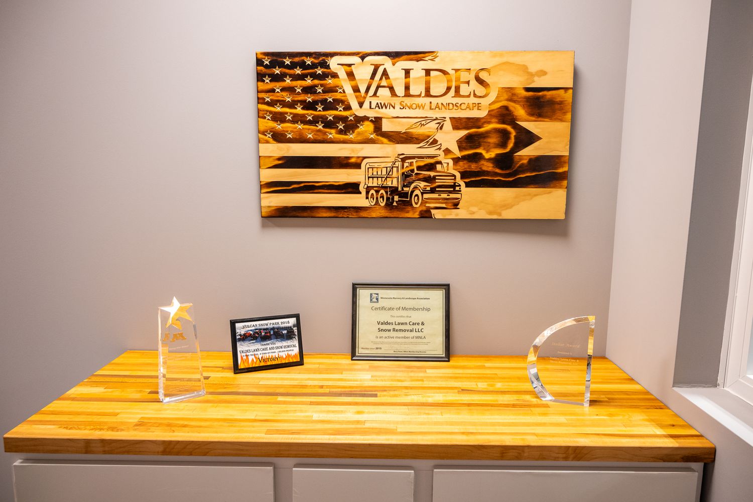 Wooden wall art displays with custom text and decorative designs in rustic style.