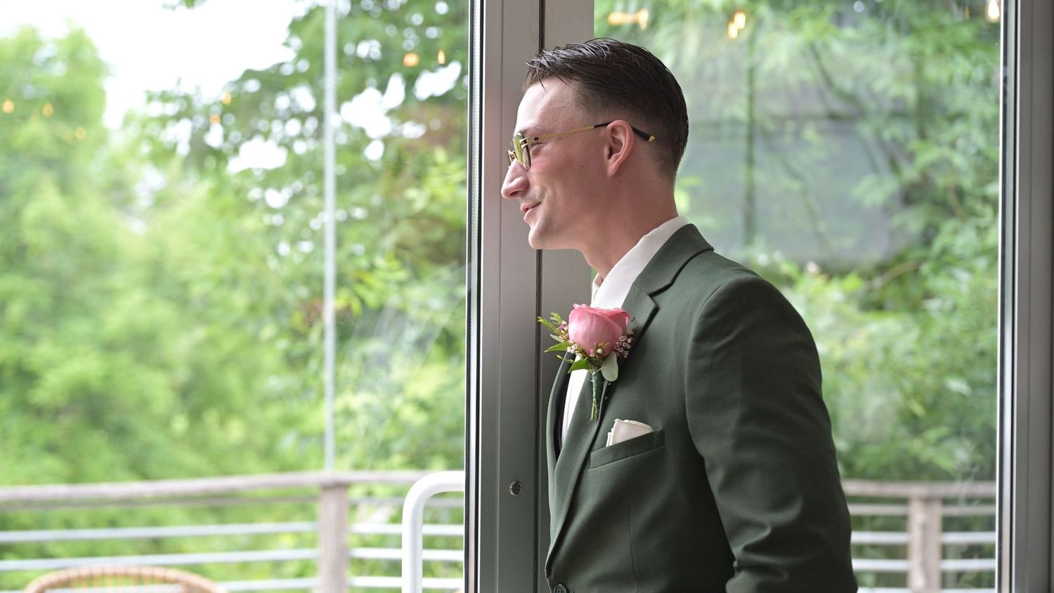 Wedding venue interior with elegant window views of green summer landscape.