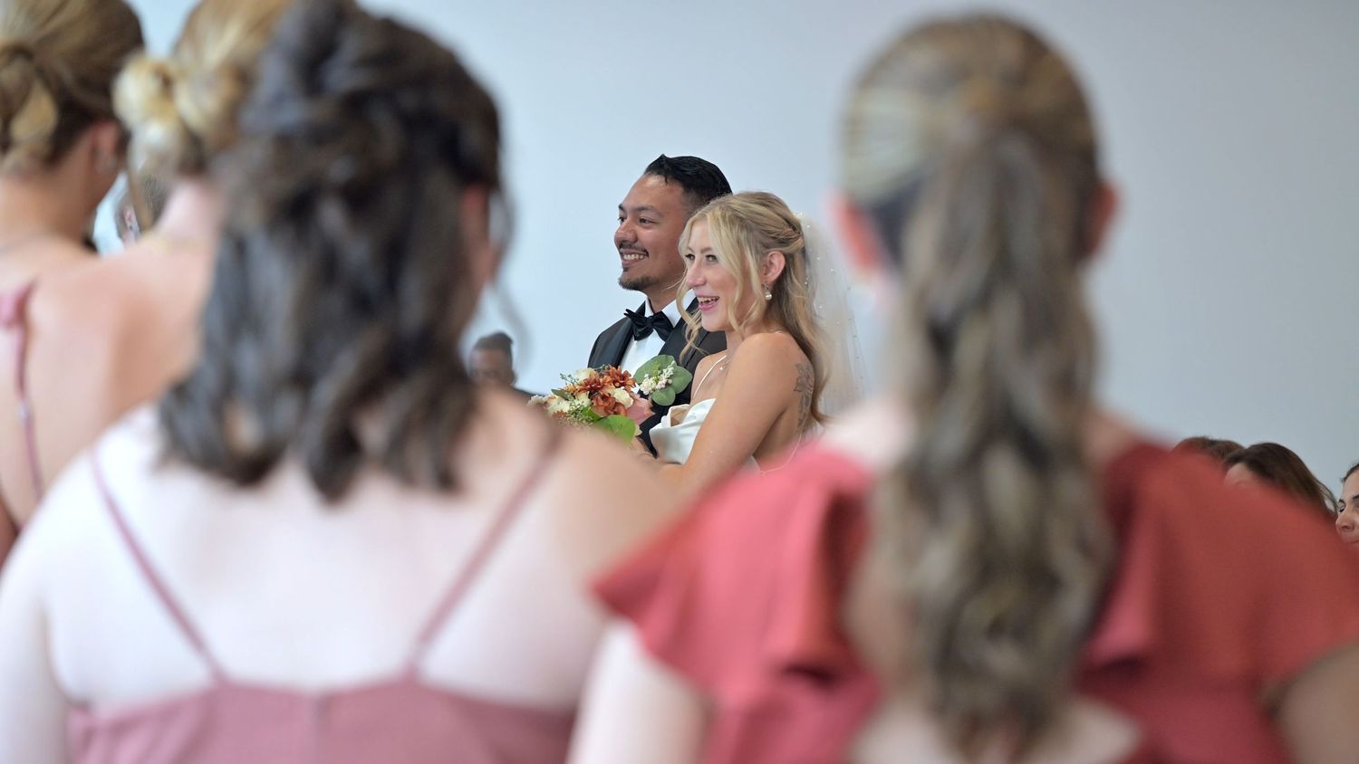 Wedding party members lined up during formal ceremony proceedings.