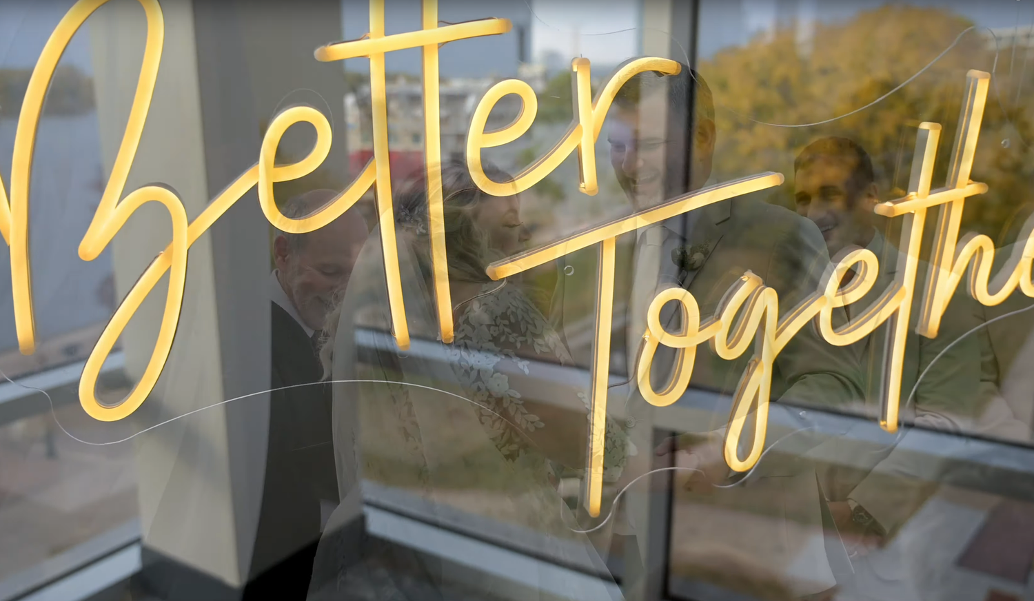 Decorative gold script text overlays showing wedding-related words and phrases against a blurred background.