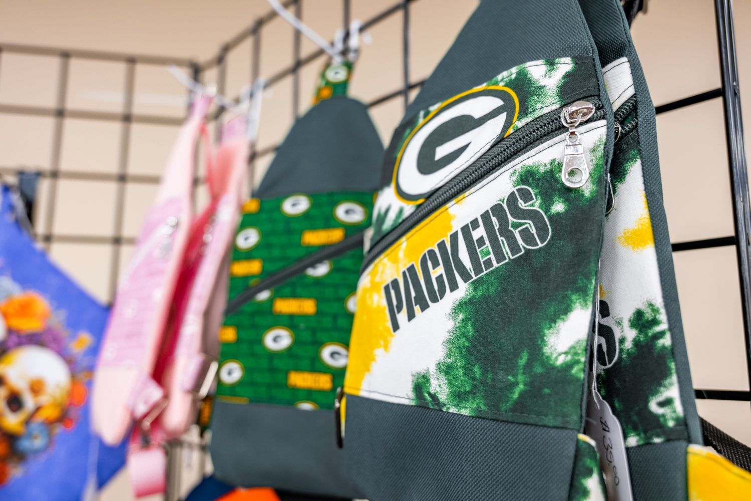 Row of Green Bay Packers flags and sports memorabilia on display.
