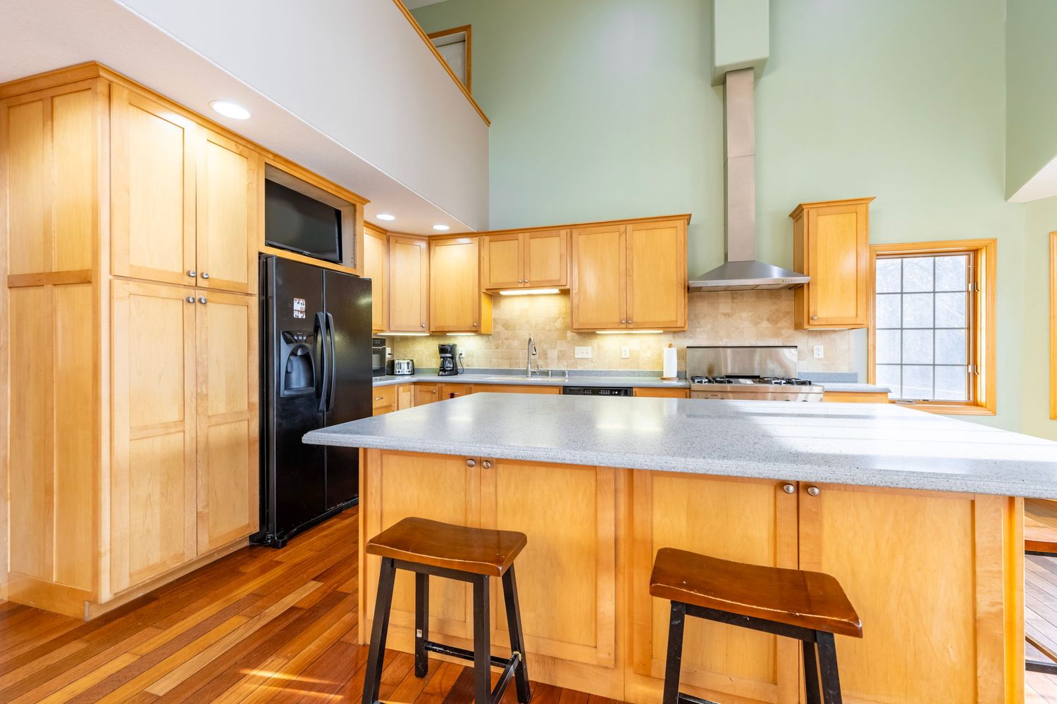 Spacious open concept kitchen featuring honey oak cabinets and expansive countertops.