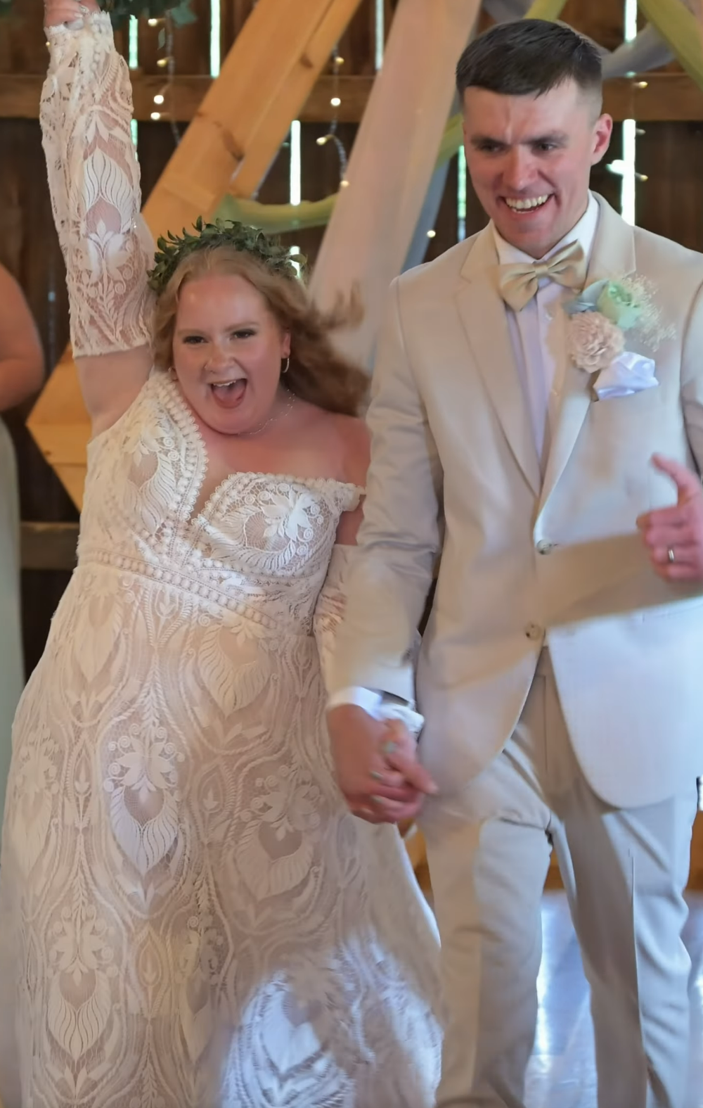 Wedding couple shares joyful dance moments in elegant attire at their reception.