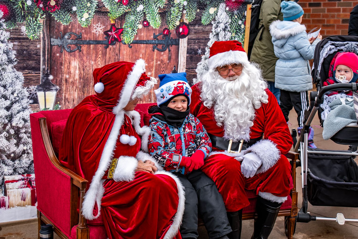 Holiday celebration with festive decorations and seasonal characters in red suits.