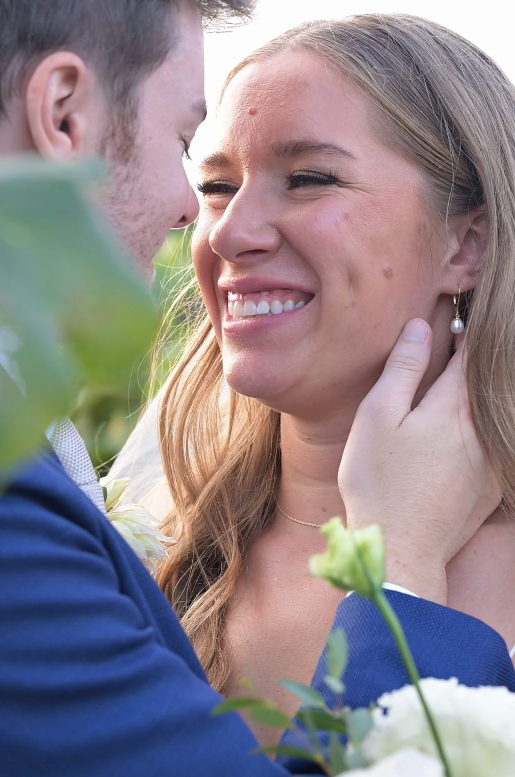 Tender moments captured between a couple during their outdoor engagement or wedding shoot.