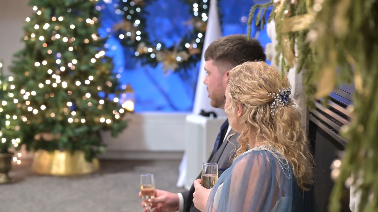 Festive Christmas trees with blue lights and decorations create a magical holiday atmosphere.