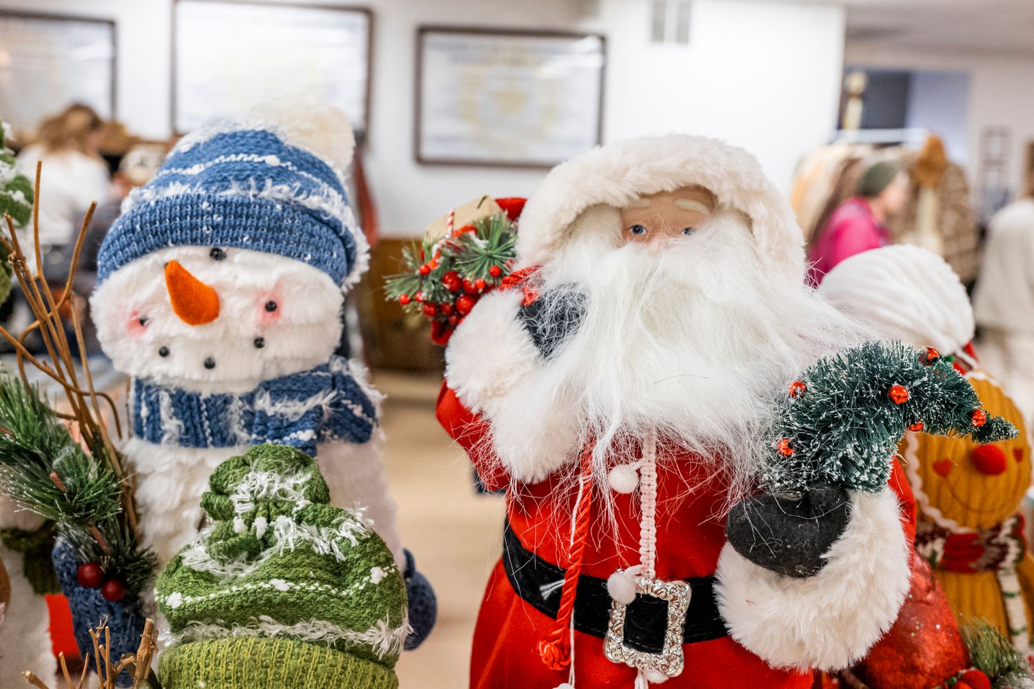 Festive Christmas decorations featuring snowmen and Santa Claus figures displayed in a holiday arrangement.